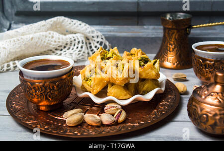 Arabic baklava dessert with coffee in copper cups Stock Photo