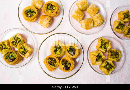 Various Arabic desserts on plates top view Stock Photo