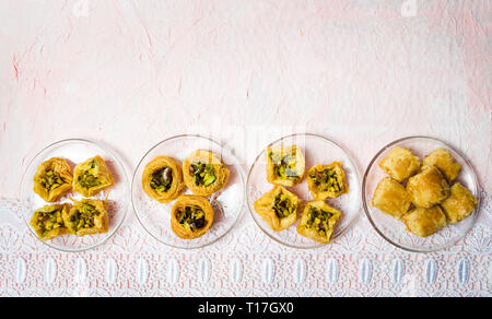 Various Arabic desserts on plates top view Stock Photo