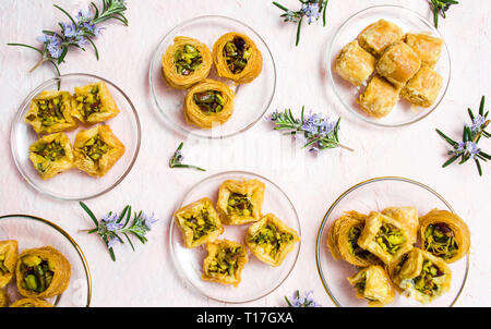 Various Arabic desserts on plates top view Stock Photo