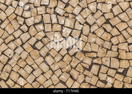 Street tile in Portugal. Light stone as a paving material. Stock Photo