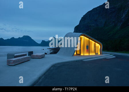 Wave shaped concrete glass modern architecture of Ureddplassen rest area with figure, Helgelandskysten Norwegian Scenic Route Nordland Norway tourism Stock Photo