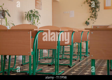 Interior of empty classroom with chairs and desks in a row. Stock Photo