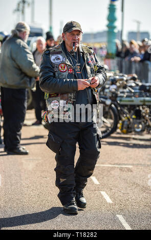 Brighton, UK. 24th March 2019. Visitors enjoy the 80th Anniversary Pioneer Run for pre 2015 veteran motorcycles in Brighton . The run organised by the Sunbeam Motor Cycle Club begins on the Epsom Downs in Surrey and finishes on Madeira Drive on Brighton seafront Credit: Simon Dack/Alamy Live News Stock Photo