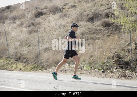 Madrid, Spain. 24th Mar 2019.  Runner of the marathon vias verdes on its way through Perales de Tajuña, in Madrid, Spain. Stock Photo