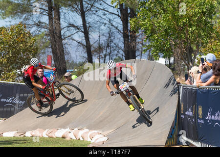 Paarl, South Africa.  24th March, 2019.  Maja Wloszczowska of Poland and Ariane Luthi of Switzerland both of team Kross-Spur Racing show us how much energy they still have at the end of one of the toughest mountain biking races in the world. Credit: Childa Santrucek/Alamy Live News Stock Photo