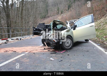 Scharfenstein, Germany. 24th Mar, 2019. Two destroyed cars are standing on the S225 Zschopau towards Scharfenstein after a collision. Three people were injured in an accident in the Erzgebirgskreis on 24.03.2019. A car had got into the oncoming traffic after a left turn near Zschopau and had collided head-on with another car, as the police reported. Credit: Kenny Langer/dpa/Alamy Live News Stock Photo
