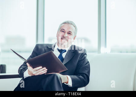 experienced lawyer reviews the documents with the terms of a new contract Stock Photo