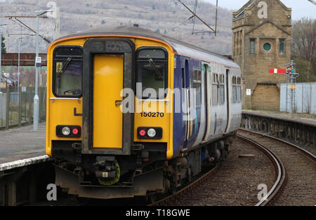 Class 150 sprinter diesel mutiple unit in Northern livery leaving Carnforth railway station with an ordinary passenger service on 21st March 2019. Stock Photo