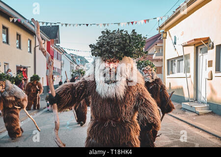 Haired wild man posing in front of the camera. Carnival party in southern Germany - Black Forest. Stock Photo