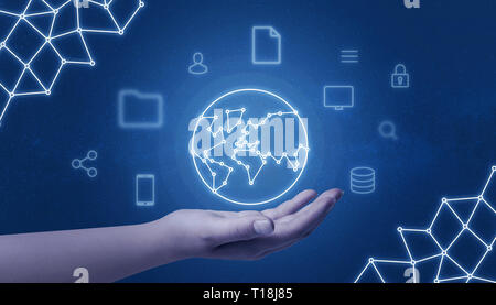 Hand holding world network concept map surrounded with internet of things icons on blue background. Stock Photo