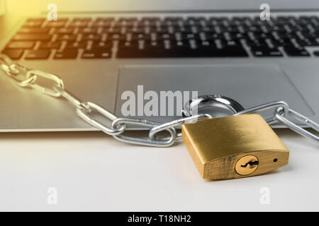 Padlock and chain with laptop computer on a white background. Cyber security abstract concept. Stock Photo