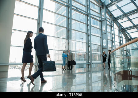 Business people walking on a modern walkway in office building Stock Photo