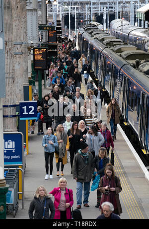 Passengers disembark onto platform from Scotrail train  at Waverley Station iN Edinburgh, Scotland, UK