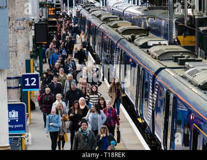 Passengers disembark onto platform from Scotrail train  at Waverley Station iN Edinburgh, Scotland, UK