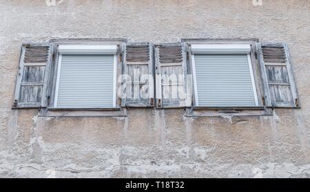 Old window with closed wooden shutters, Germany Stock Photo