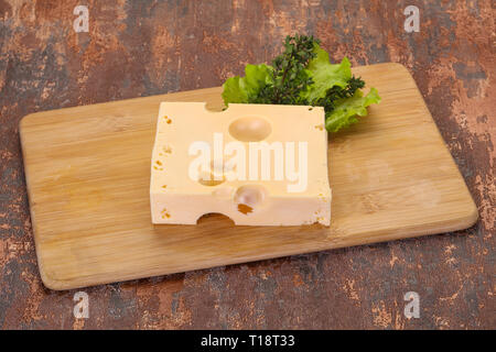 Maasdam cheese brick with thyme branch Stock Photo