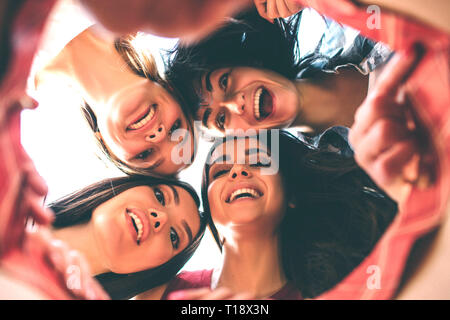 Nice and attractive young women are looking down together in bag. They are happy and excited. Also ladies are smiling Stock Photo