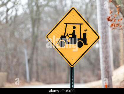 Yellow and black road sign depicting a golf cart and golfer Stock Photo
