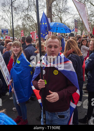 London, England, UK. 23rd March 2019, Anti Brexit Protestor draped in EU Flag on the March in London UK. Credit J Walters/Alamy Live News Stock Photo