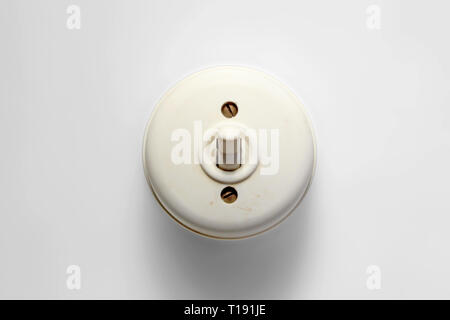 Antique switch on off, white bakelite 50s/60s, isolated on white background, closeup Stock Photo