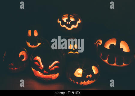 Ghost pumpkins on Halloween. ead Jack on Dark background. Holiday indoor decorations. Stock Photo