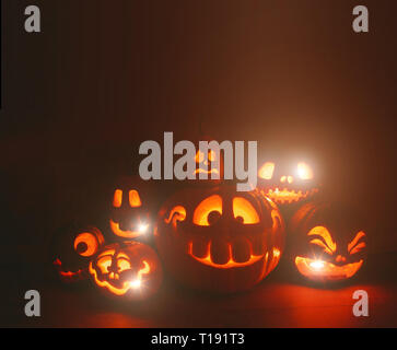 Ghost pumpkins on Halloween. ead Jack on Dark background. Holiday indoor decorations. Stock Photo