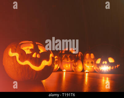 Ghost pumpkins on Halloween. ead Jack on Dark background. Holiday indoor decorations. Stock Photo