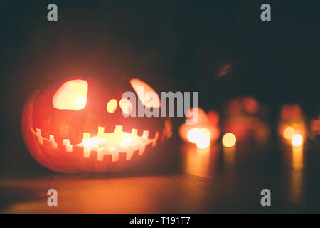 Ghost pumpkins on Halloween. ead Jack on Dark background. Holiday indoor decorations. Stock Photo