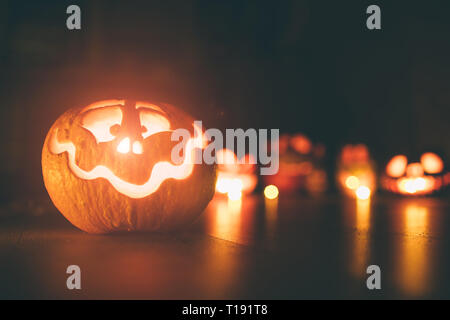 Ghost pumpkins on Halloween. ead Jack on Dark background. Holiday indoor decorations. Stock Photo