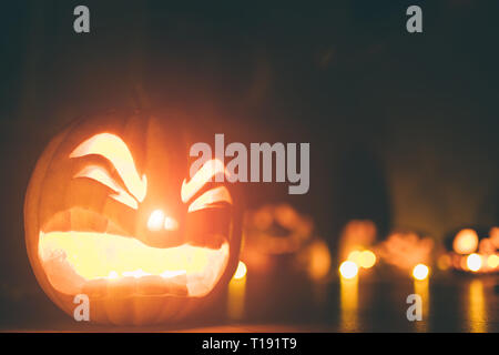 Ghost pumpkins on Halloween. ead Jack on Dark background. Holiday indoor decorations. Stock Photo