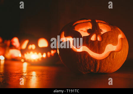 Ghost pumpkins on Halloween. ead Jack on Dark background. Holiday indoor decorations. Stock Photo