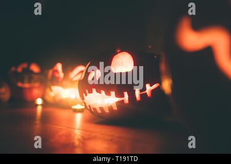 Ghost pumpkins on Halloween. ead Jack on Dark background. Holiday indoor decorations. Stock Photo