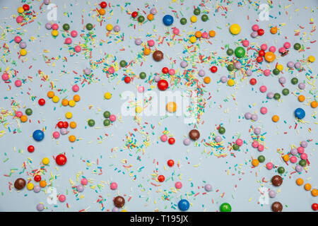 Birthday concept. Colorful sprinkles and candies on pastel blue background, top view Stock Photo