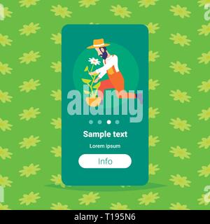 bearded gardener planting young flower in greenhouse garden farm interior organic gardening concept male cartoon character full length flat copy space Stock Vector