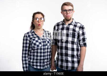 Nerds, geek, bespectacled and funny people concept - a couple of nerds in glasses on white background Stock Photo