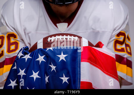 American football ball with national flag. Stock Photo