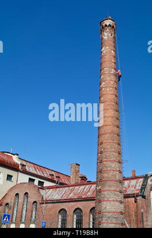 Cimbing the old factory chimney Stock Photo