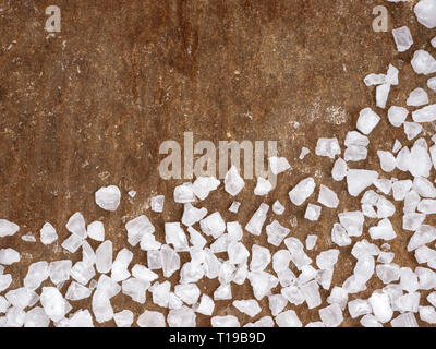 coarse salt closeup on baking parchment background with copy space. Top view or flat lay. Stock Photo