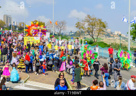 Nesher, Israel - March 22, 2019: People, some in costumes, celebrate the Jewish holyday of Purim in the Adloyada parade, in Nesher, Israel Stock Photo