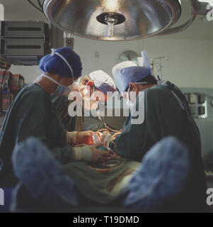 Medicine. Surgical team operating on patient. Stock Photo