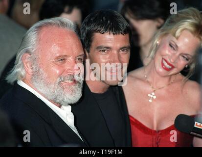LOS ANGELES, CA - July 11, 1998:  Actors SIR ANTHONY HOPKINS (left), ANTONIO BANDERAS & wife MELANIE GRIFFITH at the world premiere, in Los Angeles, of their new movie 'The Mask of Zorro.' Stock Photo