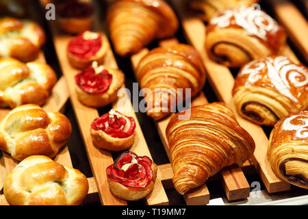 Freshly baked pastry on display in bakery shop. Selective focus. Stock Photo