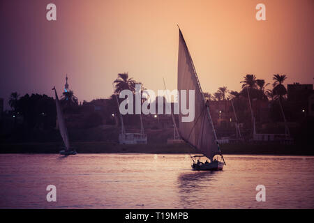 Sailboats at sunset on the Nile River in Luxor, Egypt Stock Photo