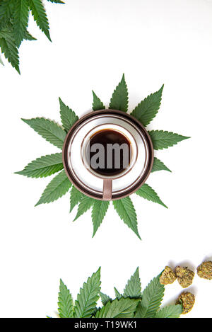 Coffee cup and cannabis concept with beans, nugs and marijuana leaves isolated on white, marijuana edibles concept Stock Photo