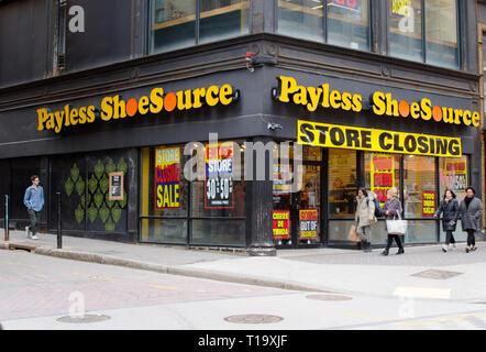Payless Shoe Source store closing with going out of business signs and motion of people walking by at Downtown Crossing in Boston, Massachusetts USA Stock Photo