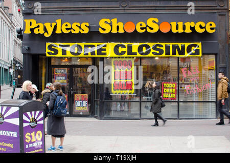 Payless Shoe Source store closing with going out of business signs and motion of people walking by at Downtown Crossing in Boston, Massachusetts USA Stock Photo