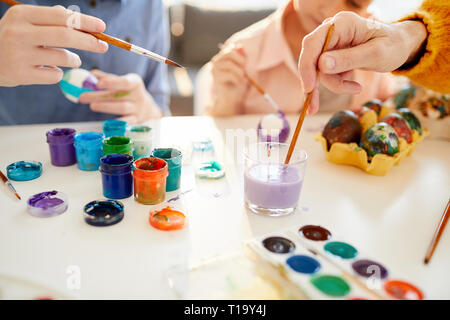 Family Painting Eggs for Easter Close Up Stock Photo