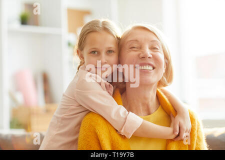 Cute Girl Embracing Grandma Stock Photo