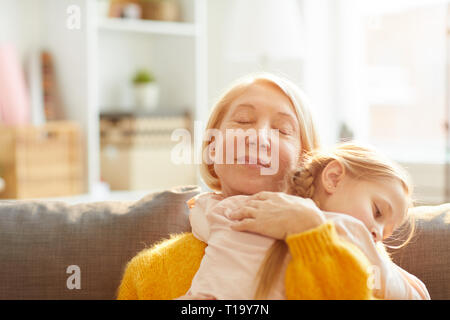 Loving Mother Embracing Daughter Stock Photo